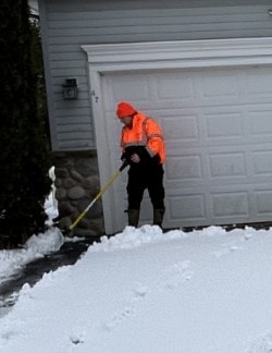 Crew member clearing residential driveway